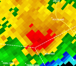 Reflectivity image (left) and velocity image (right) of the tornadic storm southwest of Richland, near the Freestone County line, at 7:35 am. In the velocity image, red indicates motion away from the radar in Fort Worth, and green indicates motion toward the radar.