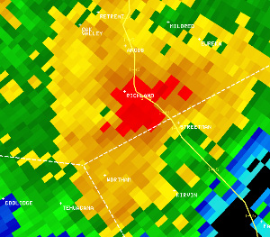 Reflectivity image (left) and velocity image (right) of the tornadic storm south of Richland, along I-45, at 7:51 am. In the velocity image, red indicates motion away from the radar in Fort Worth, and green indicates motion toward the radar.