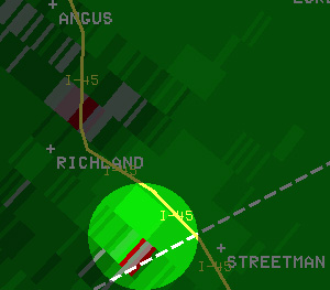 Reflectivity image (left) and velocity image (right) of the tornadic storm south of Richland, along I-45, at 7:51 am. In the velocity image, red indicates motion away from the radar in Fort Worth, and green indicates motion toward the radar.
