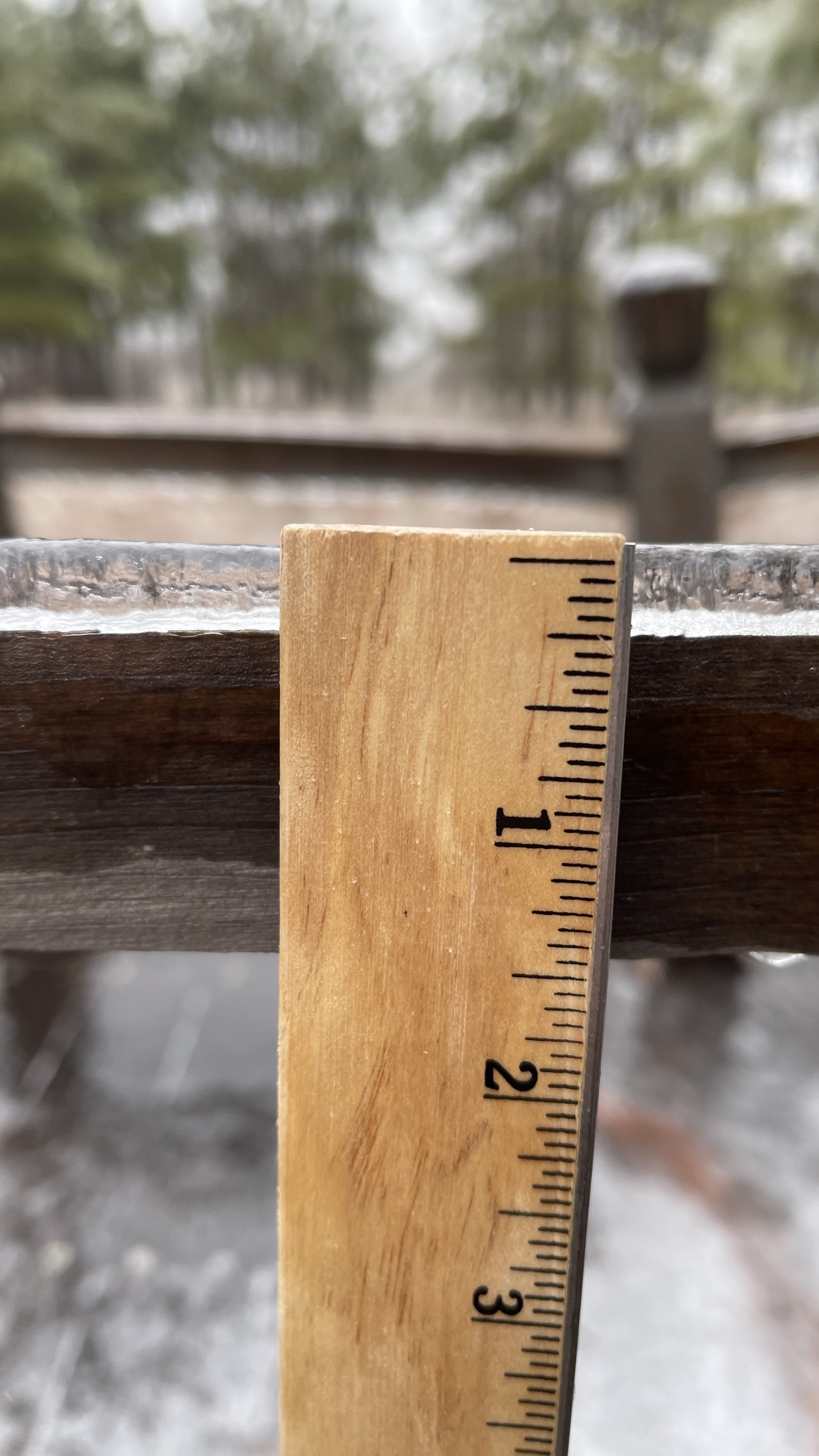 measuring ice on a surface (photo by NWS employee)