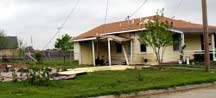 Picture of tornado damage to a house.