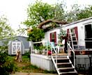 Picture of tornado damage to a mobile house.