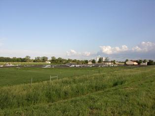 Portions of a metal building scattered in a field. Photo by NWS Staff.