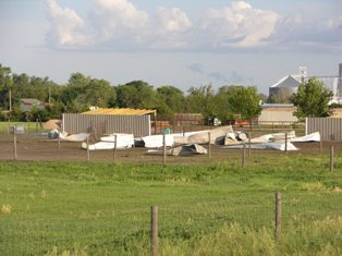 Debris scattered in a field. Photo by NWS Staff.