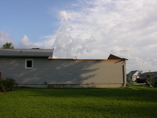Side view of roof missing from residence. Photo taken by NWS Staff.