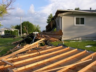Debris from roof blown off of residence. Photo by NWS Staff.