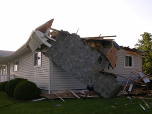  Portion of roof hanging from residence. Photo by NWS Staff.