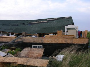 House moved from foundation north of Elm Creek, Nebraska. Photo by NWS Staff.