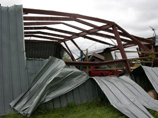 Metal building badly damaged near Amherst, Nebraska. Photo by NWS Staff.