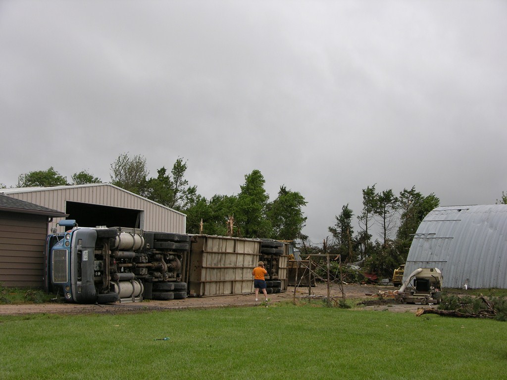 Semi overturned and tree damage by the tornado on Highway 66 near Polk, NE. Photo by NWS Staff.   