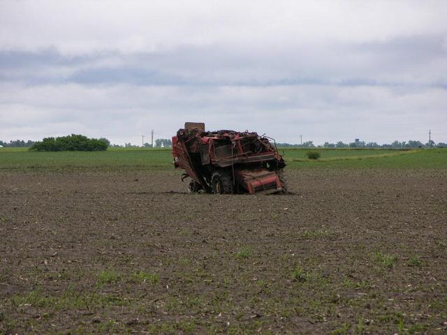 Combine crumpled and tossed in field near Bradshaw.  Photo by NWS staff.