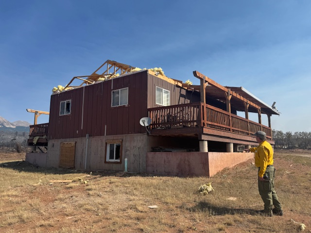 Tornado damage at the Deer Creek wildfire. Roof ripped off of house.