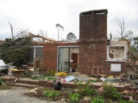 Several structures along AL Highway 79 in the Waterfront community were affected by the tornado. This house on the Tennessee River lost its roof and an entire brick wall (which would have been on the right side of this image).