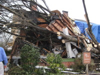 This home in the Old Town district received damage as a tree was blown onto the front porch.