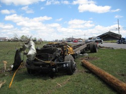 The remains of a school bus that was blown across Hwy 75 in Rainsville.  This bus was originally sitting in the parking lot in the building in the distance.  