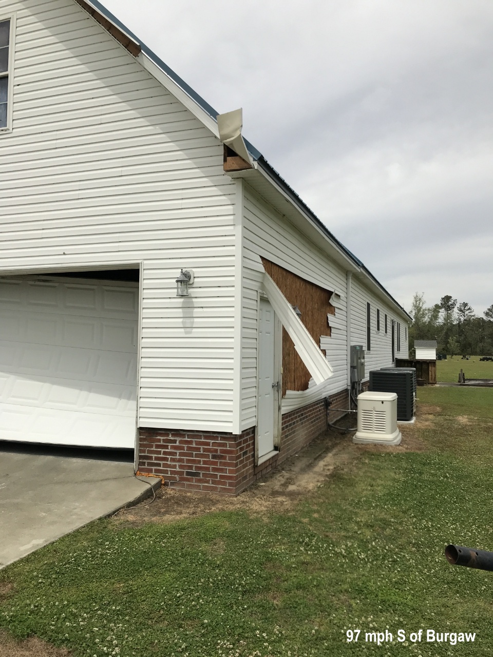 The garage door was pushed in and vinyl siding was ripped off this home south of Burgaw.  Based on observed damage, wind speeds were estimated to have reached 97 mph here.