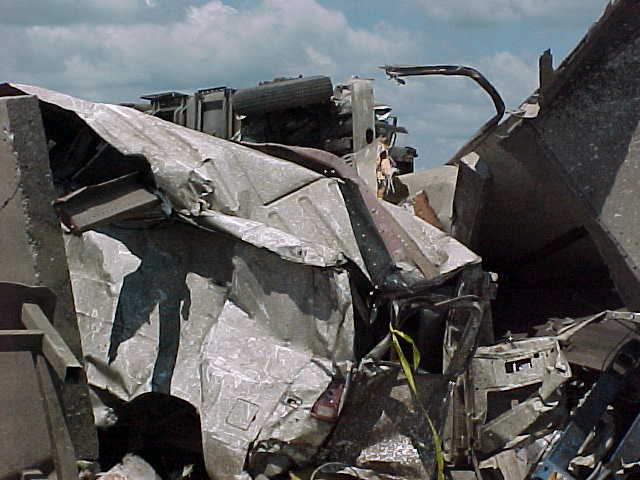 Vehicle remains are part of the debris from the loading area on the east side of the plant.