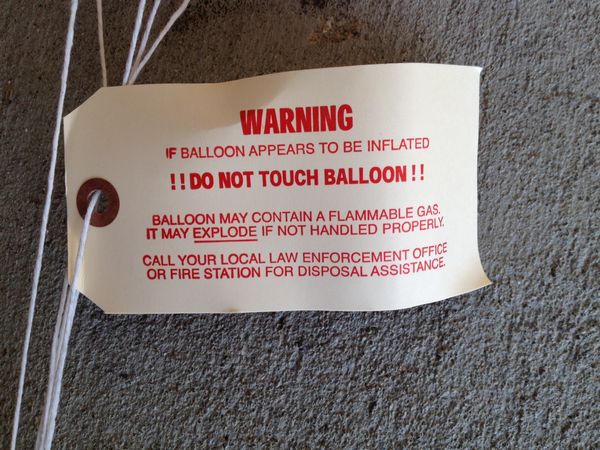 A close-up of the warning tag that is attached to the parachute
