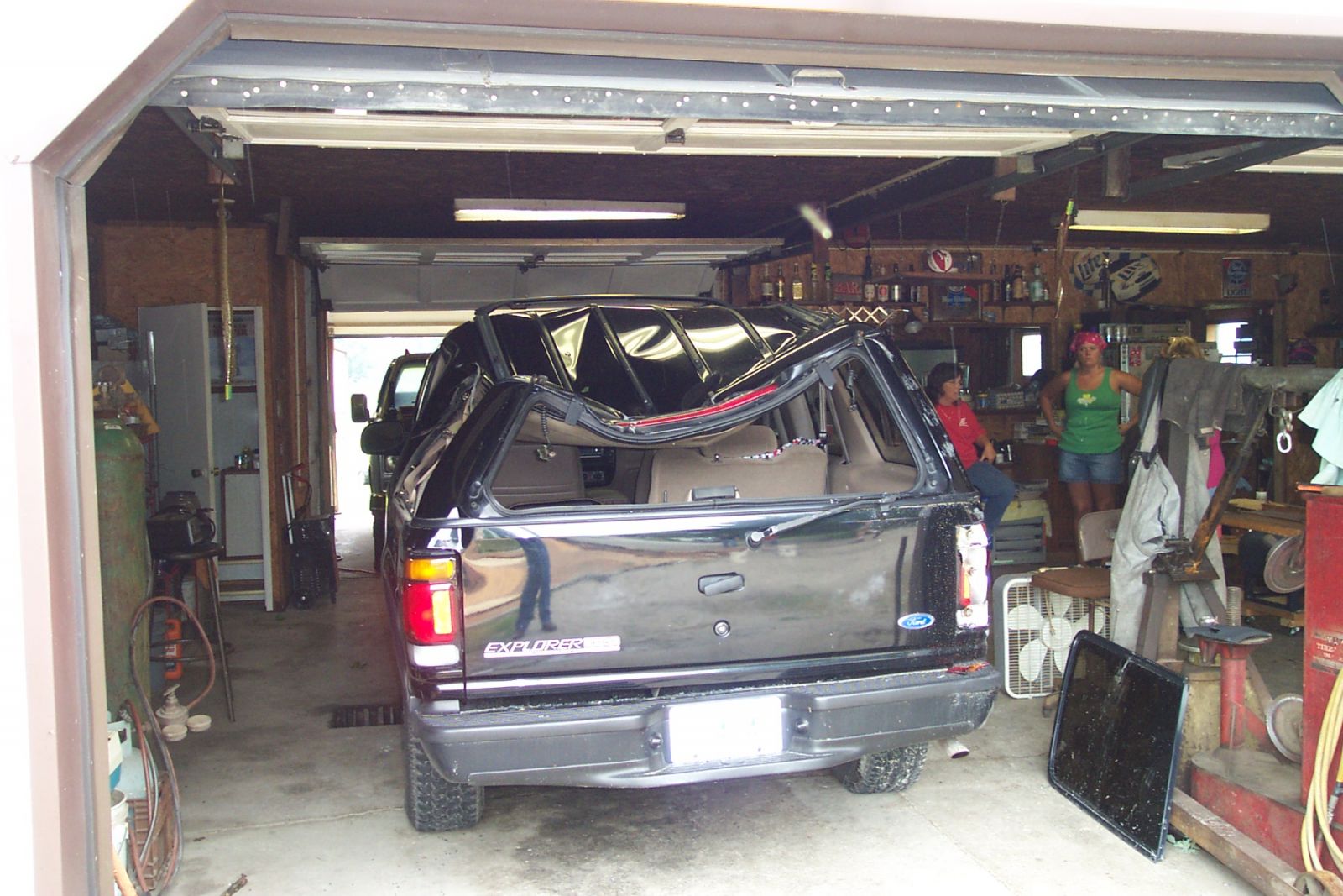 This car was crushed by a piece of roof which was torn from a home. Note, the car was outside when struck.