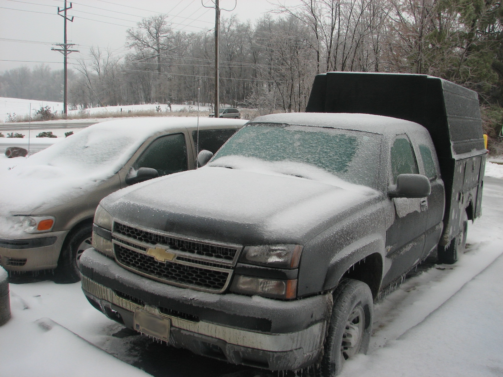 vehicles covered in a thick layer of sleet and ice.