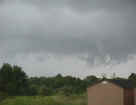 This series of four scud pictures was taken on August 19, 2001, from the parking lot at the Northern Indiana weathe roffice, facing northeast.  A shower was passing just off to the east (the light gray color along the tree line is heavy rain).