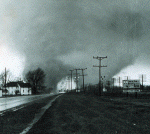 In one of the most incredible tornado photographs ever taken, monstrous double funnels rip through Midway, Indiana, between Goshen and Elkhart on Palm Sunday, April 11, 1965, at 6:32 p.m. These two massive funnels were rotating around each other, and produced F4 damage. Photo courtesy Paul Huffman, who worked for the Elkhart Truth at the time.