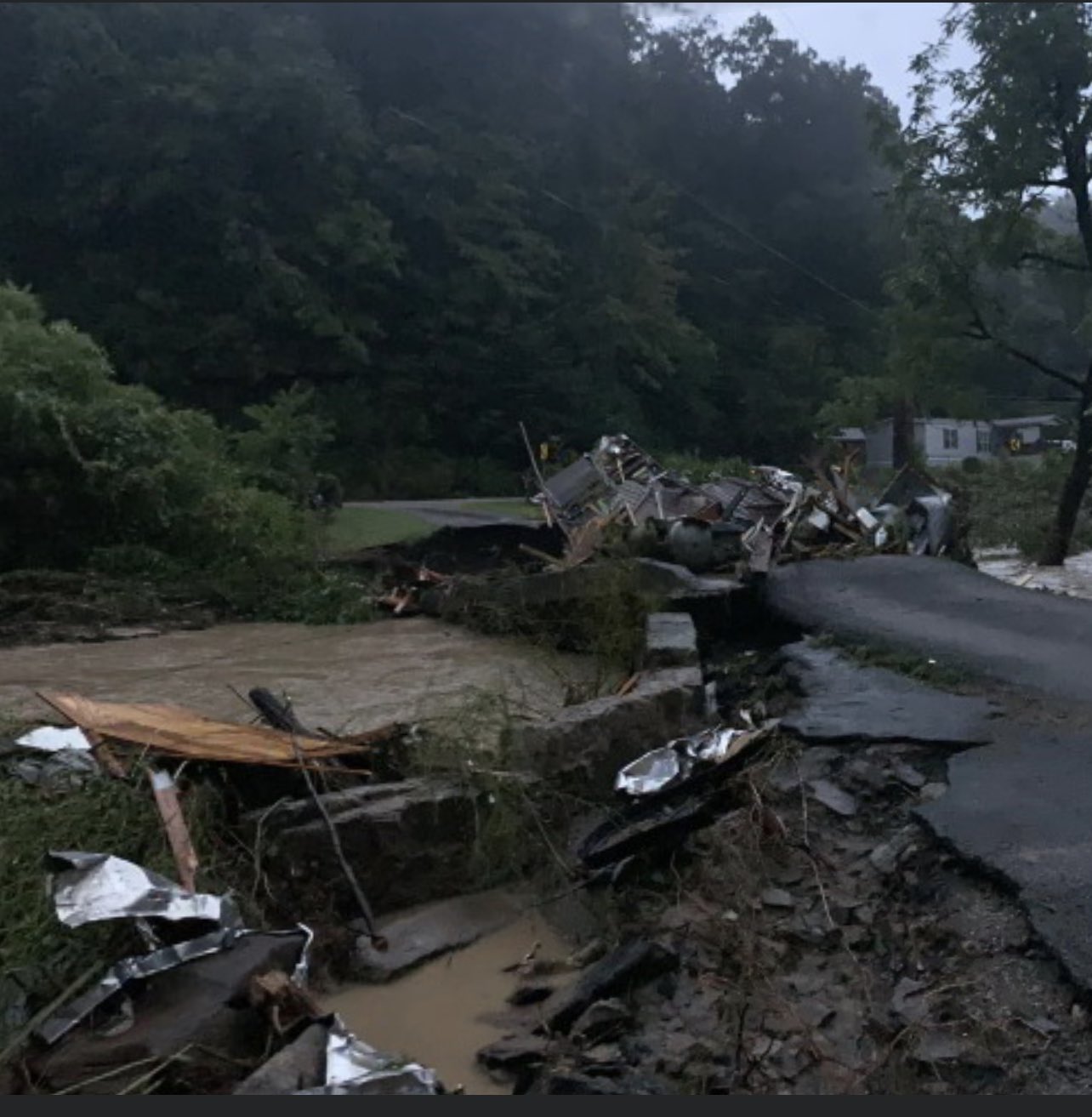 Destroyed roads and structures due to flash flooding in Chavies, KY
