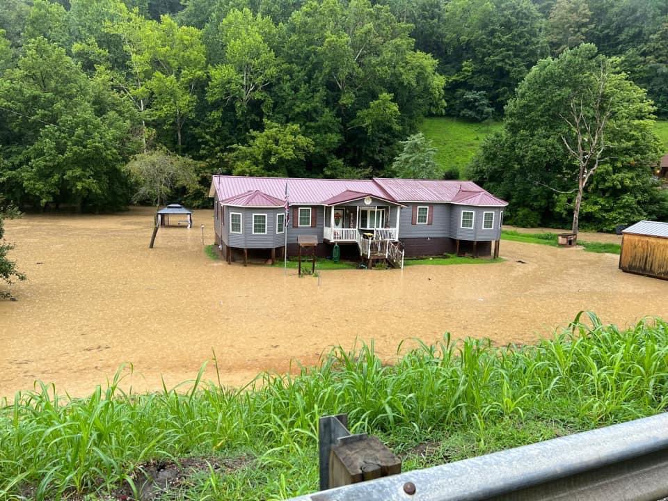 Water surrounding a home due to flooding in Floyd County, KY