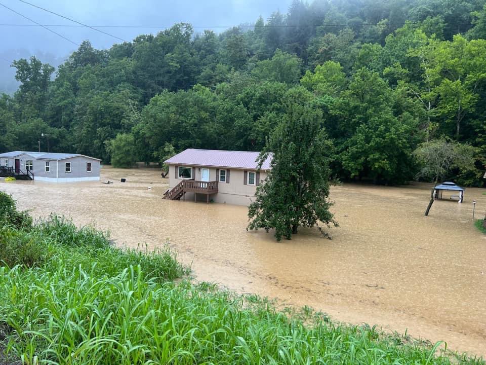 Water surrounding a home due to flooding in Floyd County, KY