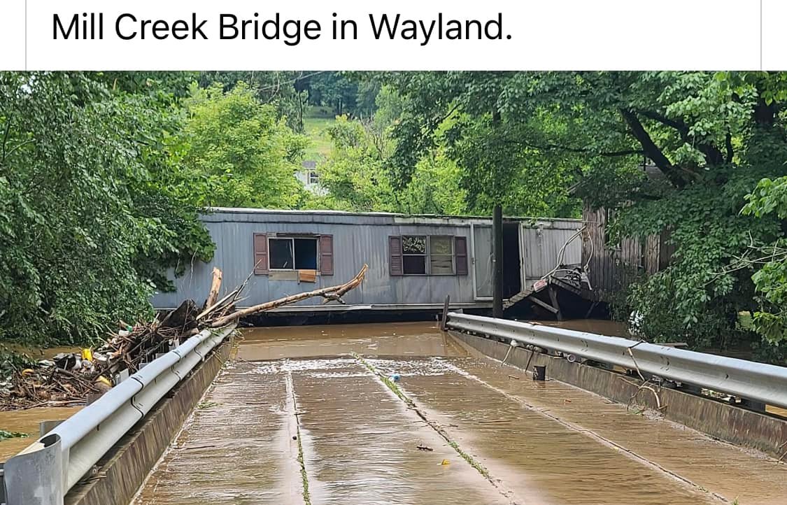 A single-wide swept across Mill Creek Bridge by flash flooding in Wayland, KY