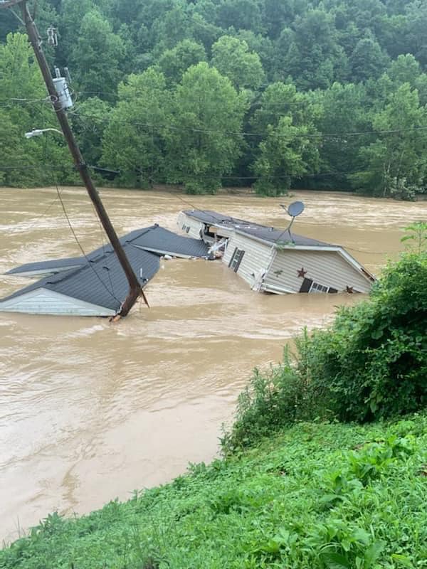 A house completely submerged in water due to flash flooding and river flooding at Nobles Landing near Troublesome Creek