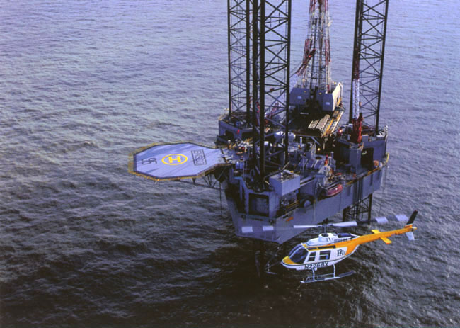 Image of a PHI helicopter preparing to land on a platform in the Gulf
