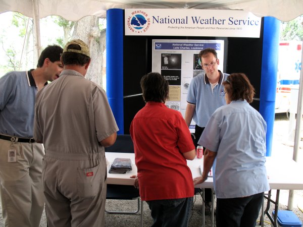 Forecaster Donovan Landreneau and WCM Roger Erickson help visitors at the NWS Booth