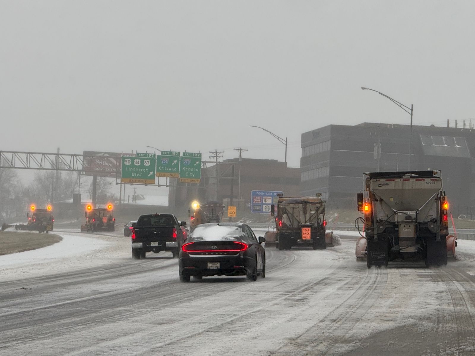 Photo of cars and snowplows on a snow-covered I-55 near Mehlville, MO.