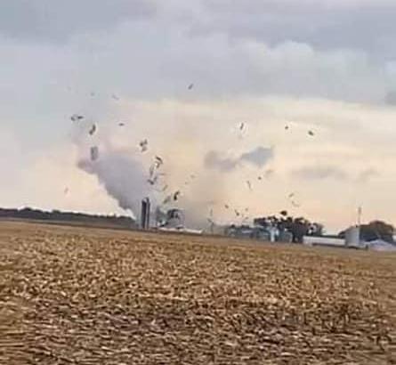 Photo of the tornado causing damage to a structure near Wrights, IL.