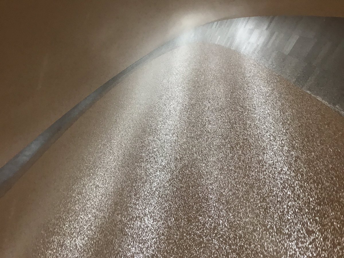 Photo of snow falling that is being illuminated by the lights at the Gateway Arch National Park.