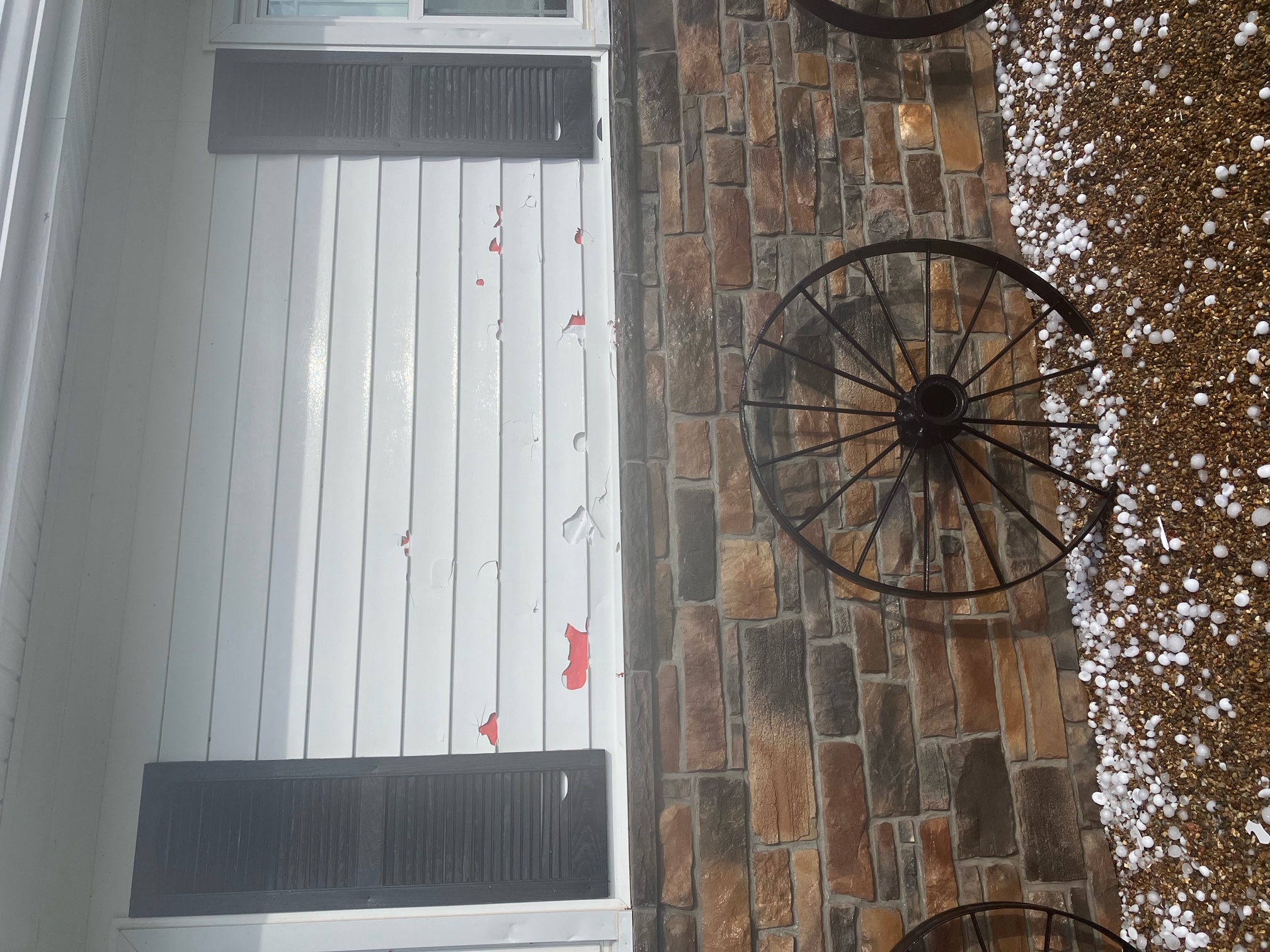 Damage to the side of a house due to large hail in Laddonia, MO.