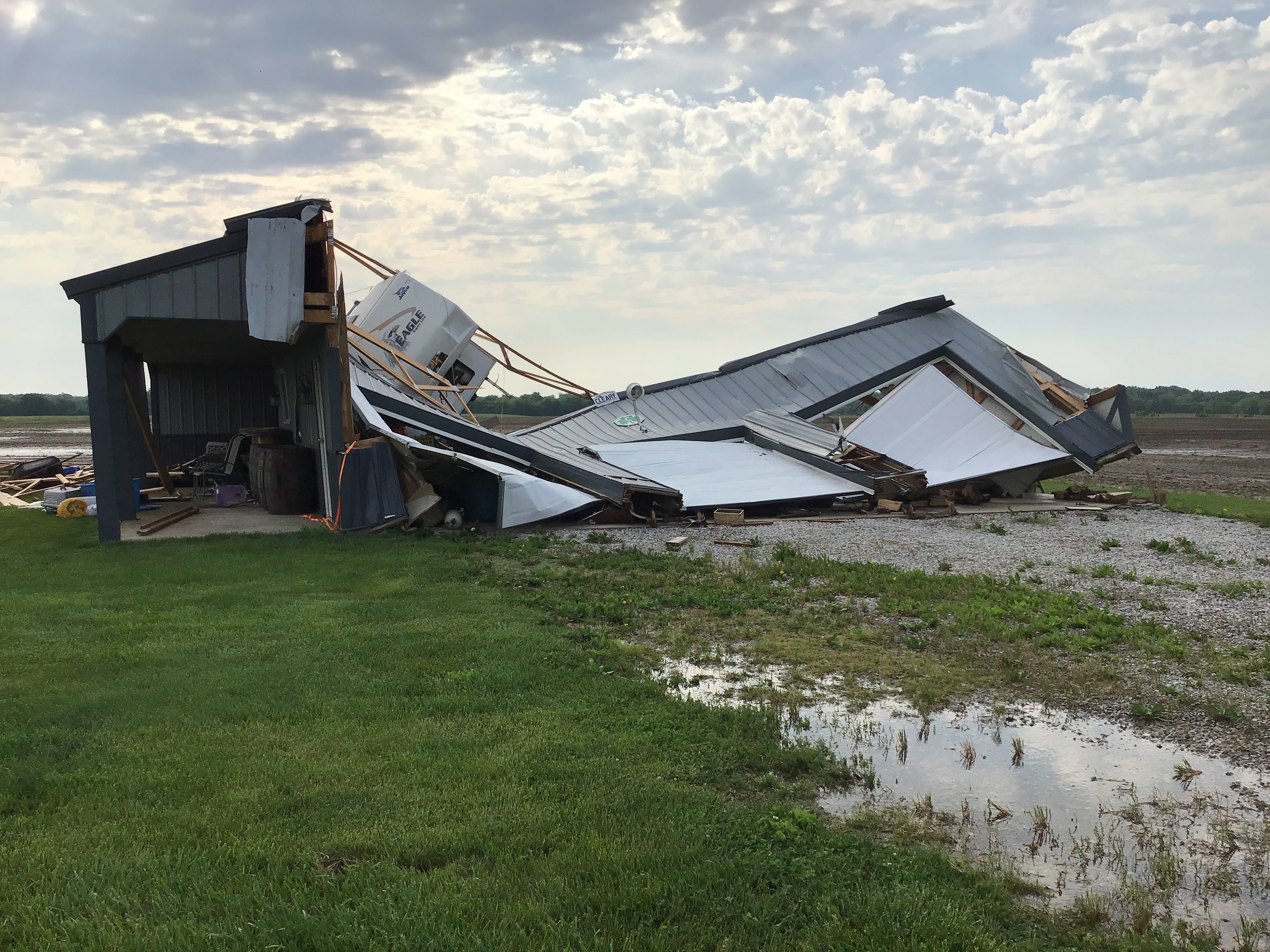 A detached garage was largely destroyed, though a small portion remains standing.
