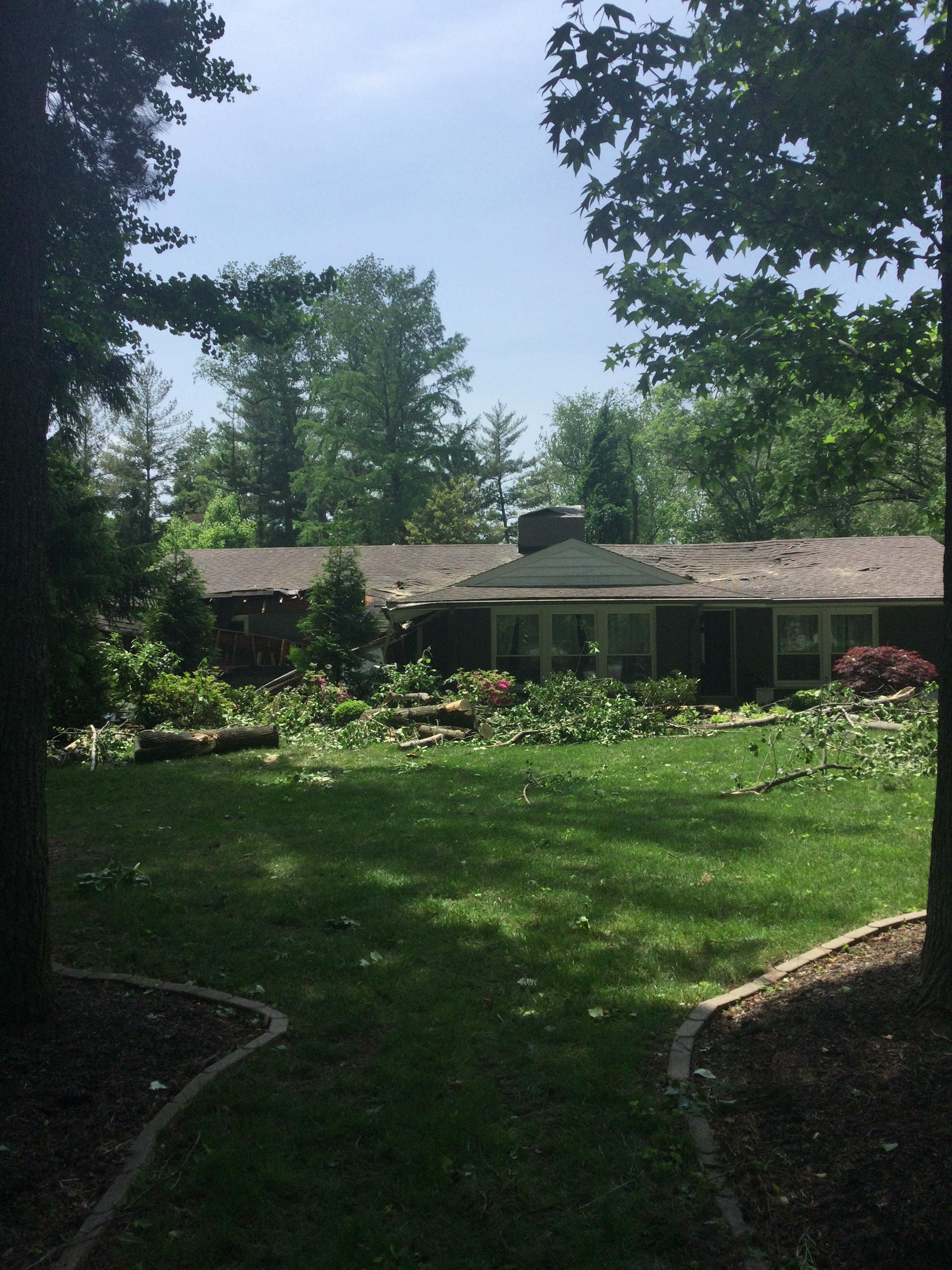 An uprooted tree fell onto part of this house in Frontenac, Missouri.