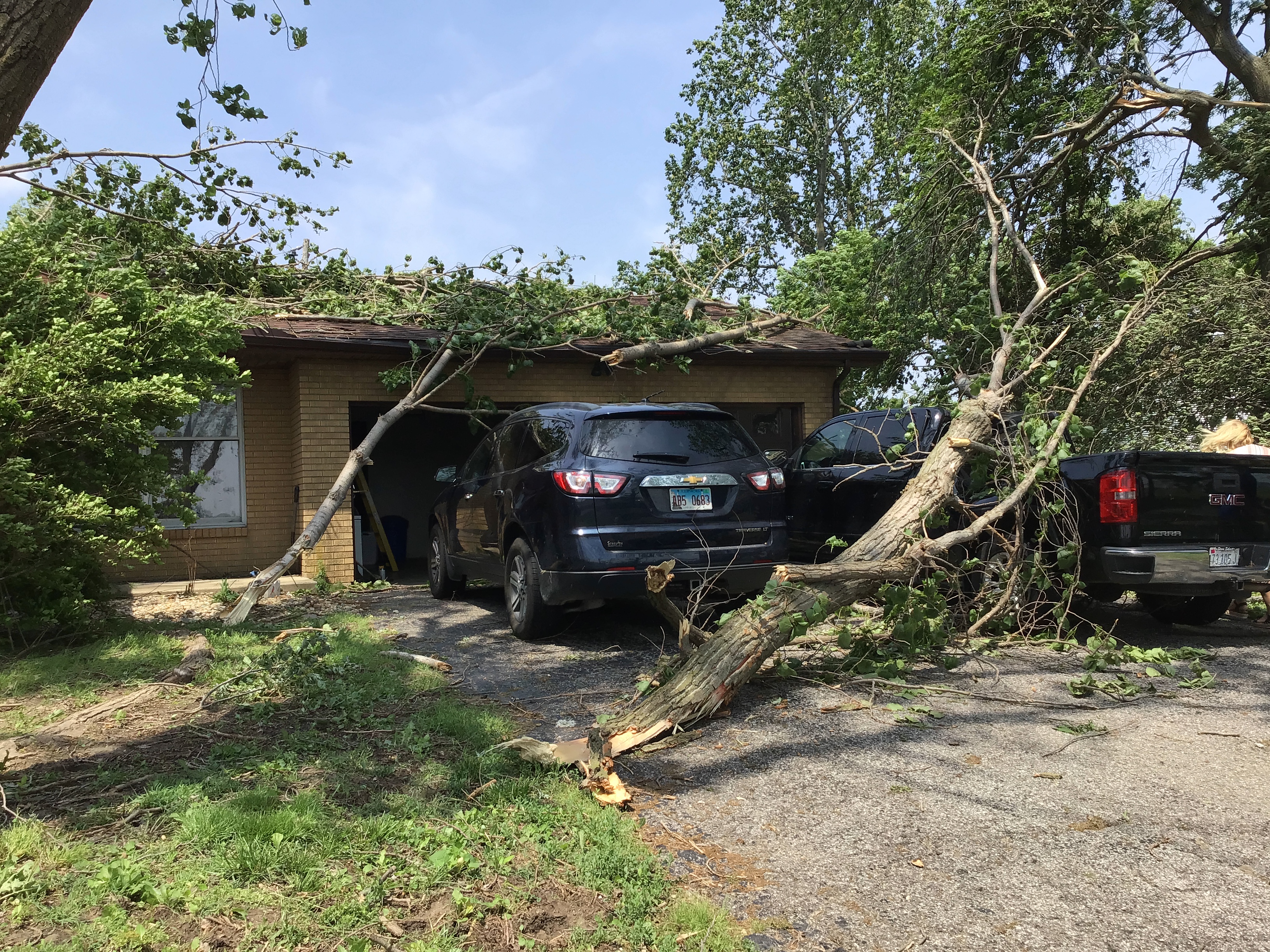 Several branches, some of them large, down on a house, car, and driveway off Summerfield St. Jacob Road in Summerfield.