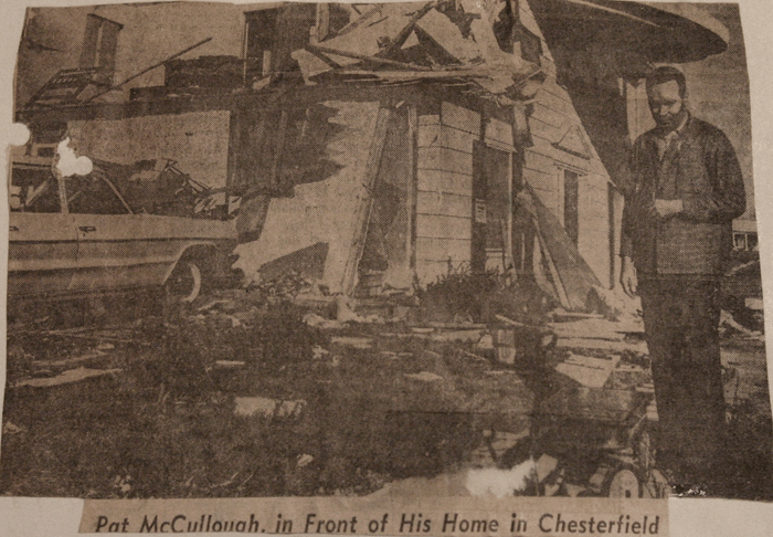 Photo of newspaper article with picture of a home damaged in Chesterfield, MO.