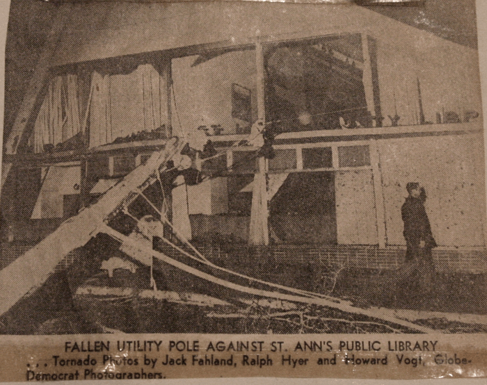 Photo of a newspaper article with a picture of the St. Ann Library on St. Charles Rock Road that sustained major damage.