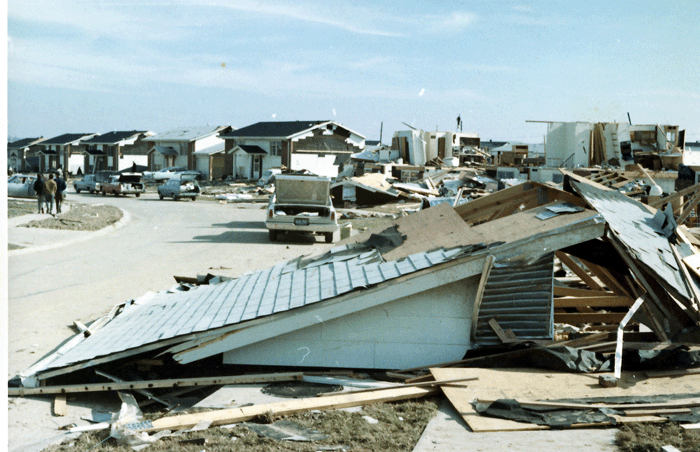 Photo of roof from a nearby house on Glengate Drive in Maryland Heights, MO. Also, several other severely damaged homes in background.