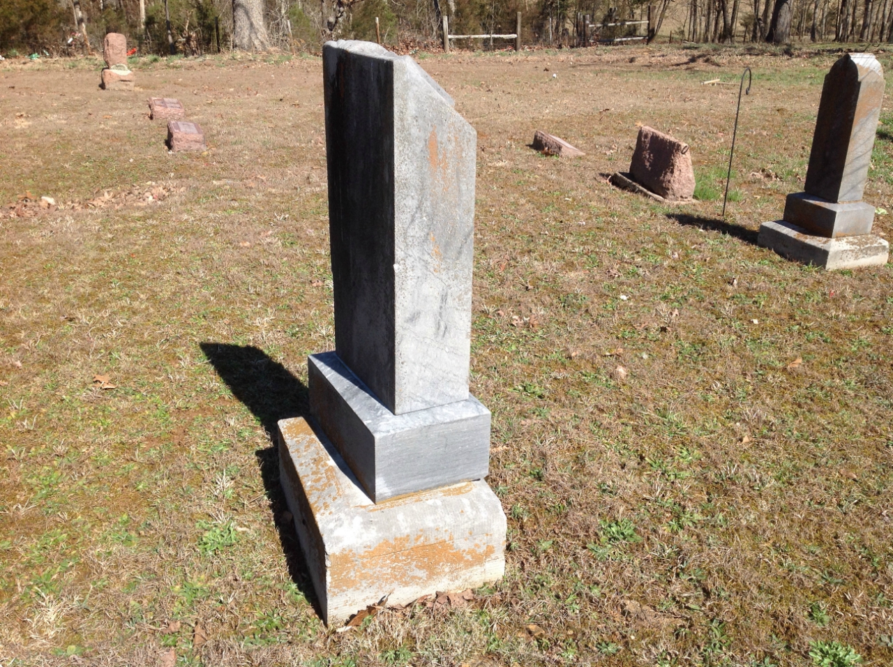 Photo of very heavy headstone in a graveyard moved on west side of Highway K.