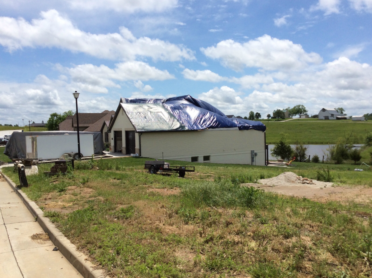 Photo of major roof damage to house on Ashbury Way, just west of Route B.