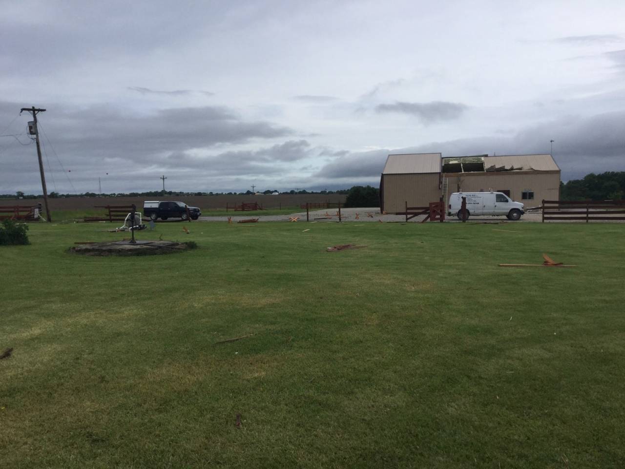 Another view ofÂ hanger building with roof panels removed and window/door blown out.