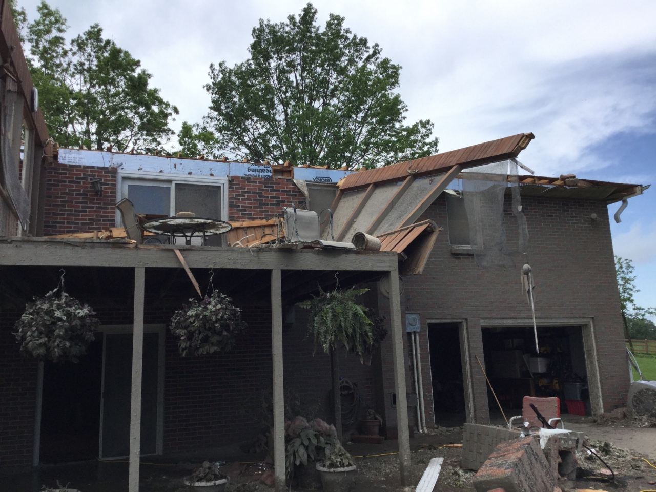 Large section of a house's roof removed by 130 mph tornadic winds.