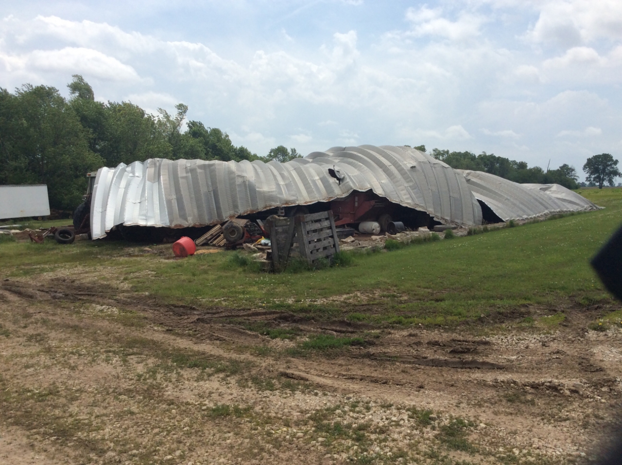 Photo of corrugated metal shed collapsed.