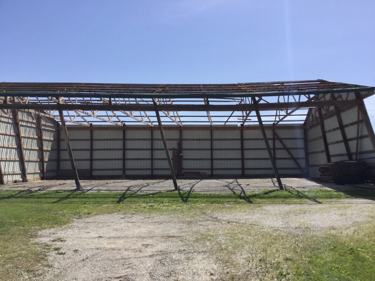 Photo of open sided barn that lost all of the roof.