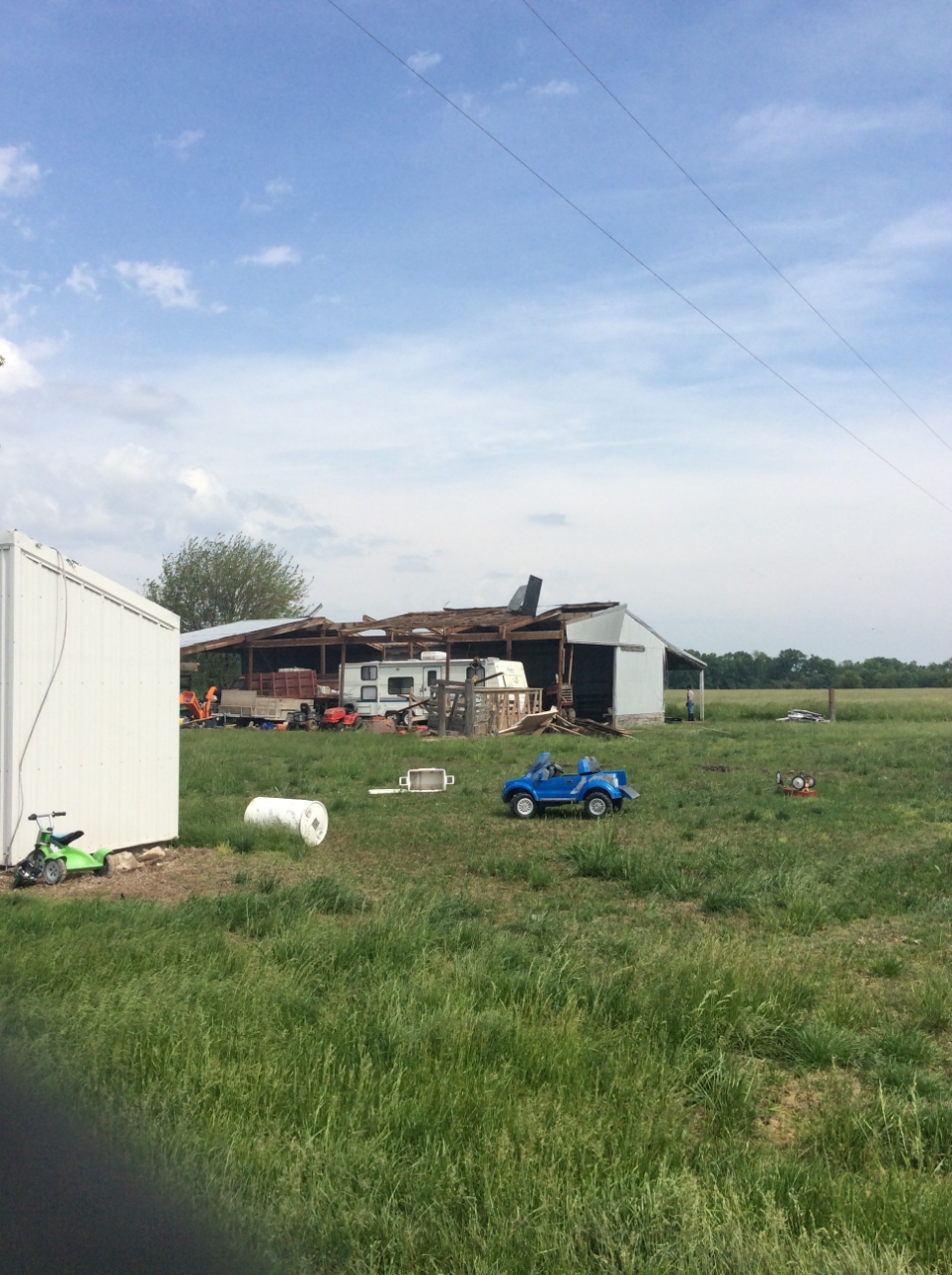 Photo of partial roof removal of outbuilding.